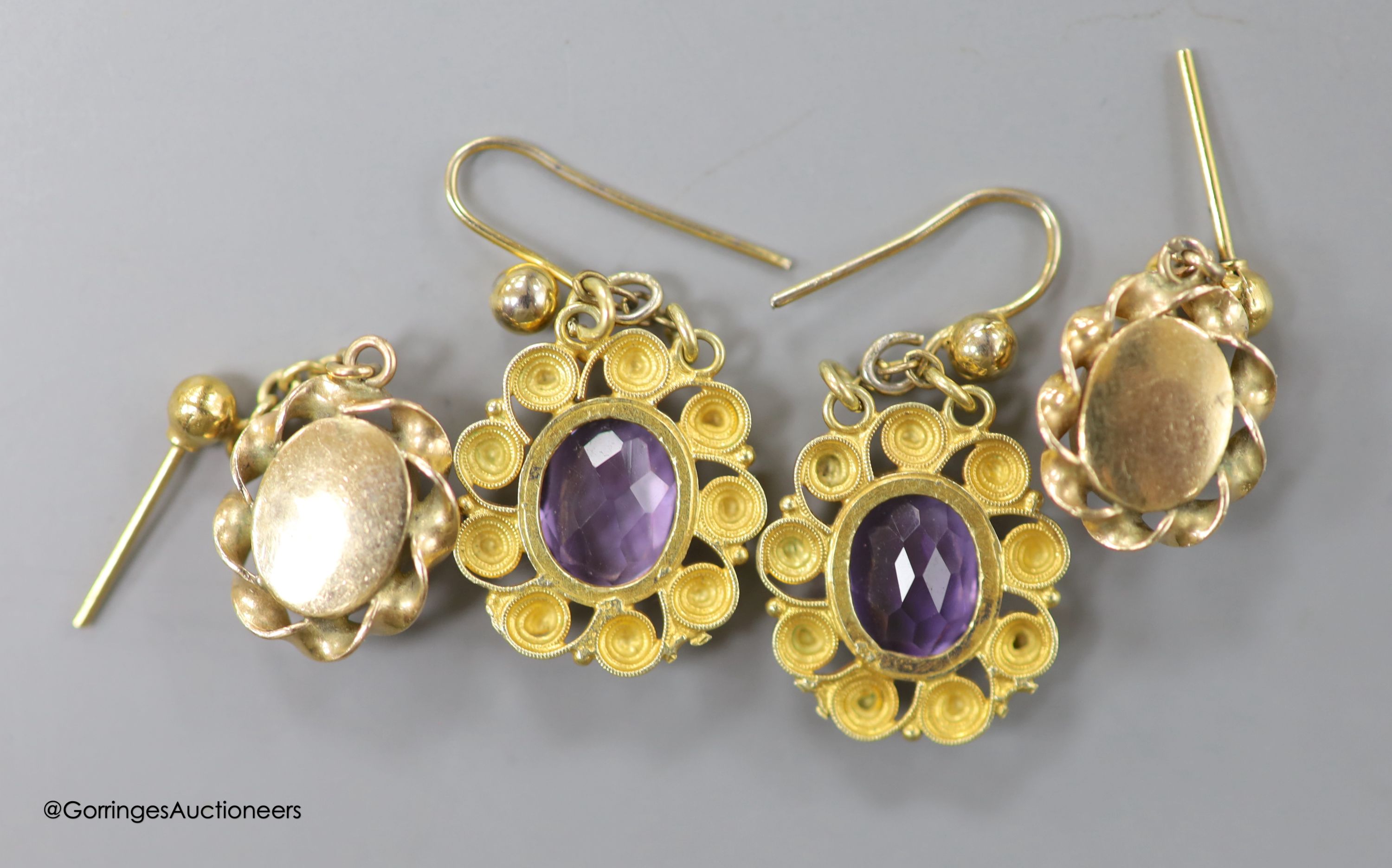 A pair of late Victorian yellow metal and amethyst set oval drop earrings, overall 24mm, and a pair of yellow metal and opal earrings